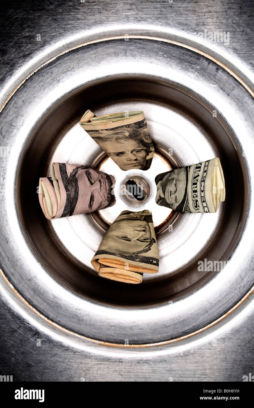 United States currency in stainless steel sink drain Stock Photo Alamy