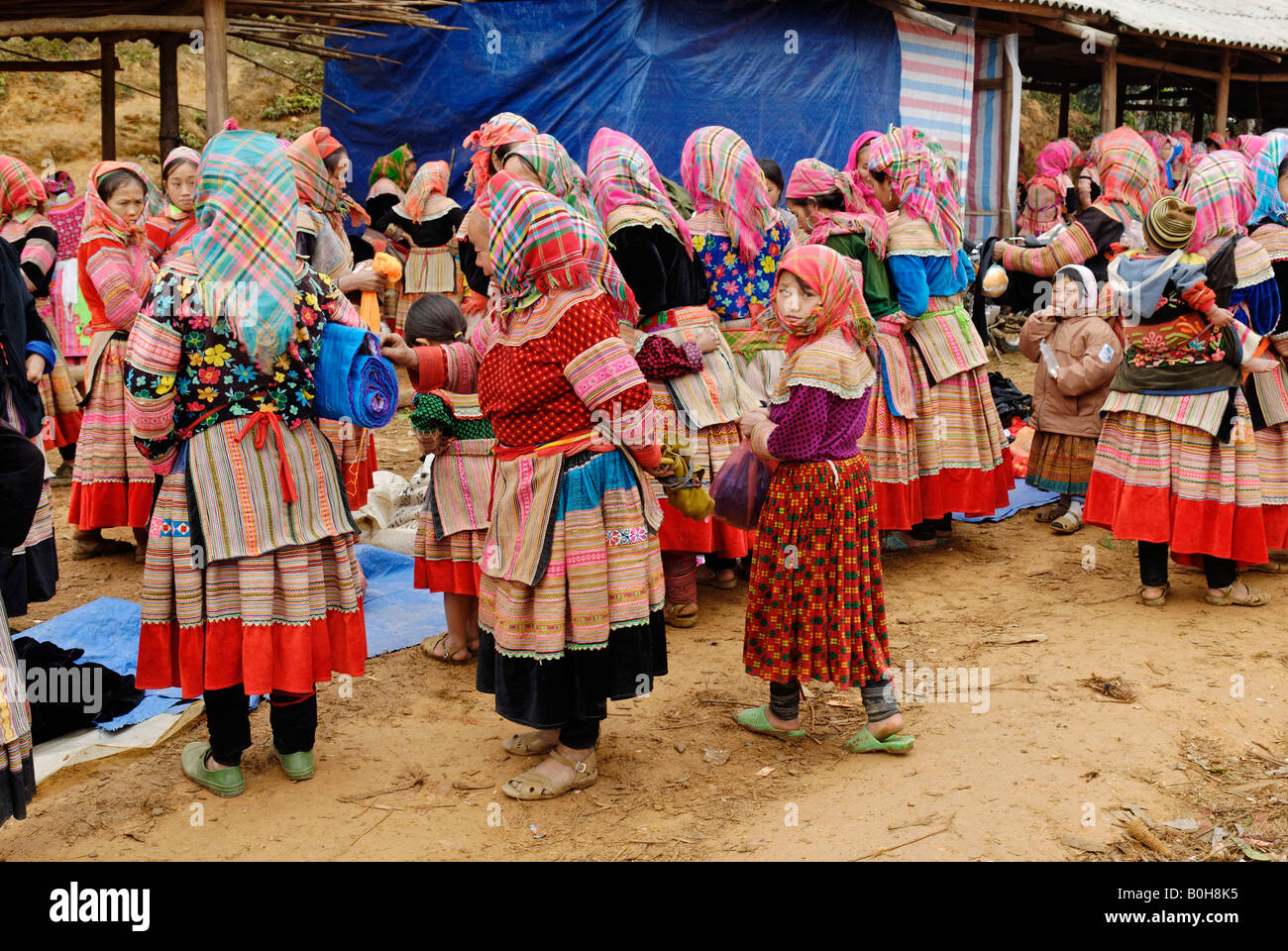 Flower Hmong, Mong, or Miao women and children in traditional dress at a market, Ha Giang Province, North Vietnam Stock Photo