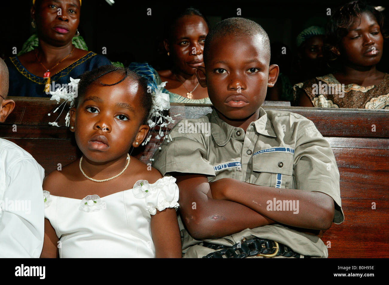 Boy and girl sitting on a church pew, Douala, Cameroon, Africa Stock Photo