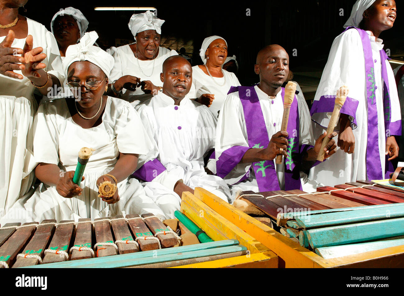 Male and female marimba players performing with the choir at a church