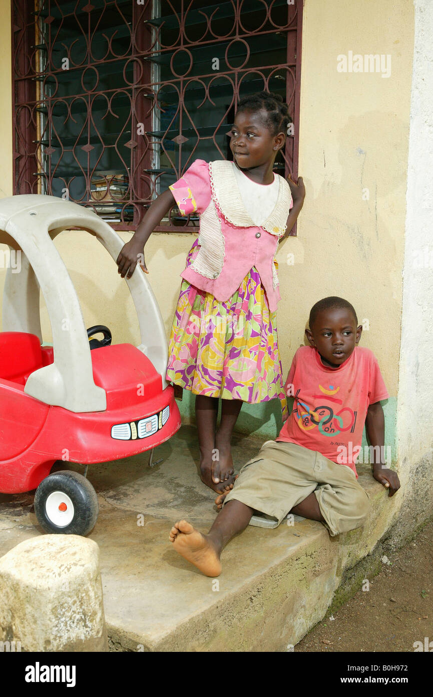 Children playing with a peddle car at an AIDS / HIV orphanage in Douala, Cameroon, Africa Stock Photo