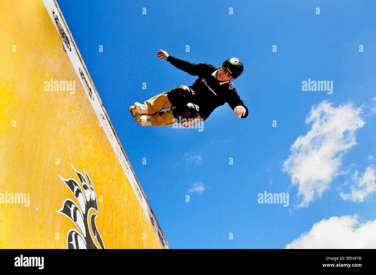 Skater, skateboarder doing jumps, half pipe Stock Photo