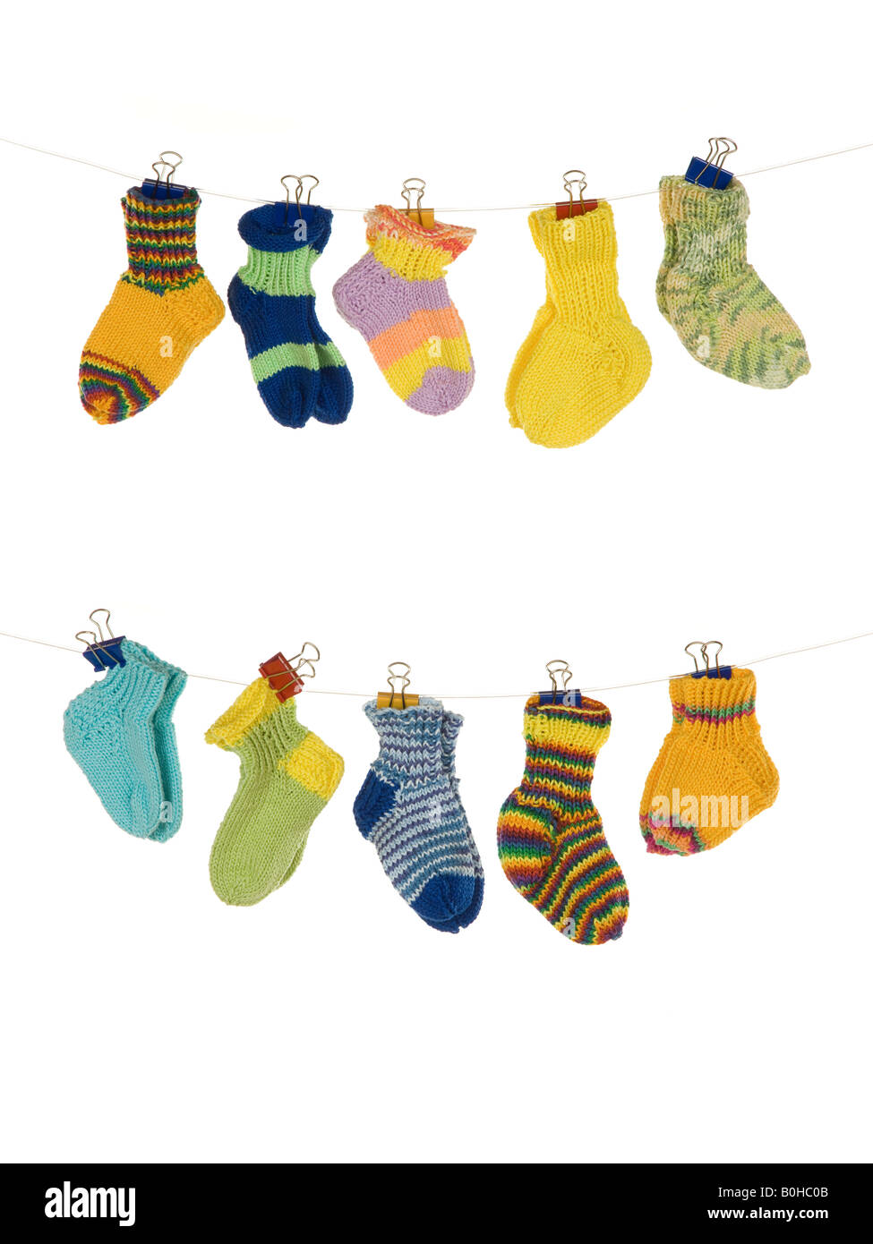 Various baby socks hanging from a clothesline Stock Photo