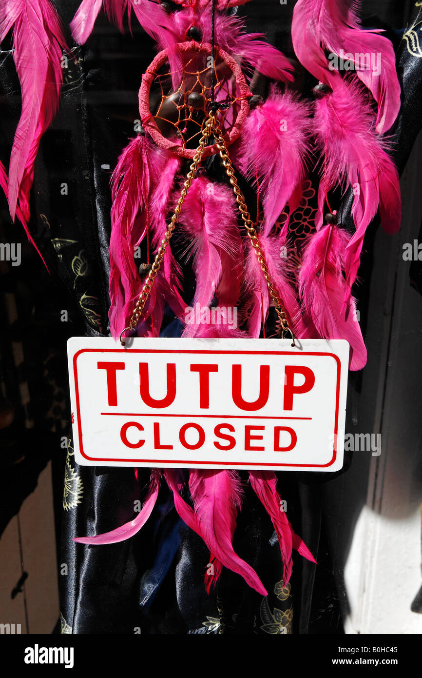 Closed sign hanging in the shop window of a fashion boutique in the Netherlands Stock Photo