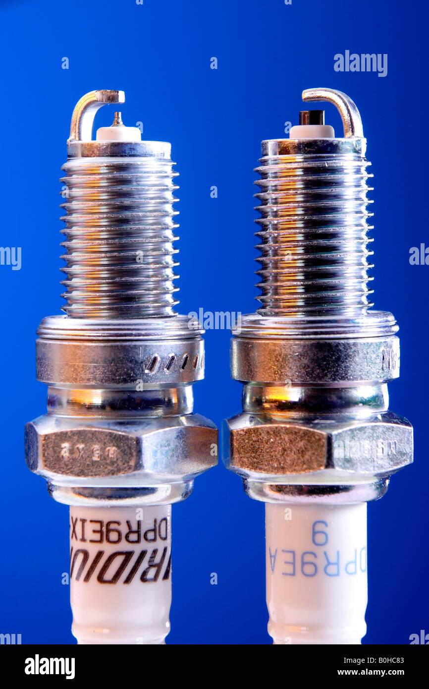 Comparison of iridium spark plug and standard spark plug Stock Photo