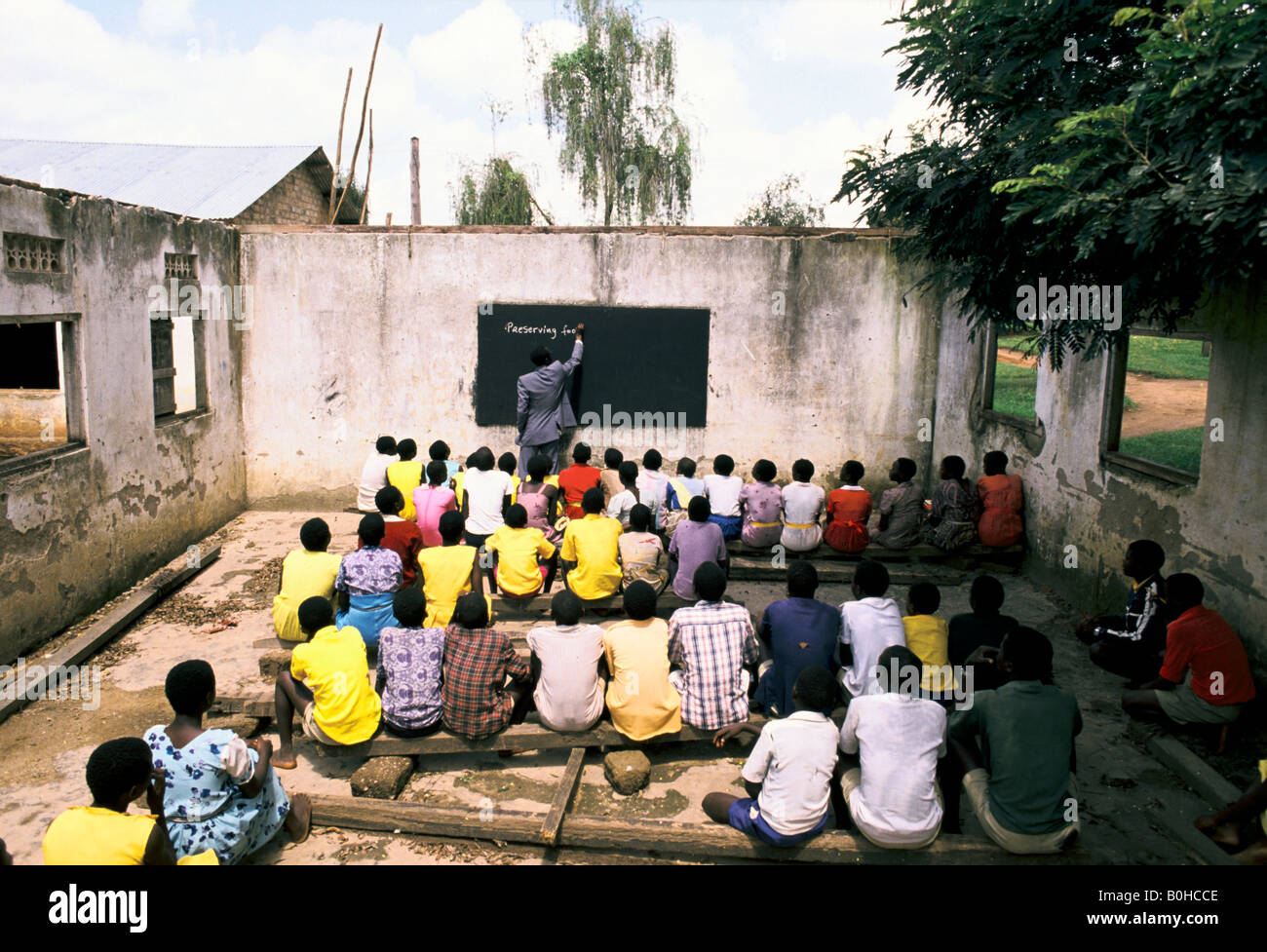A teacher giving homework at an outdoor classroom, Uganda. Stock Photo