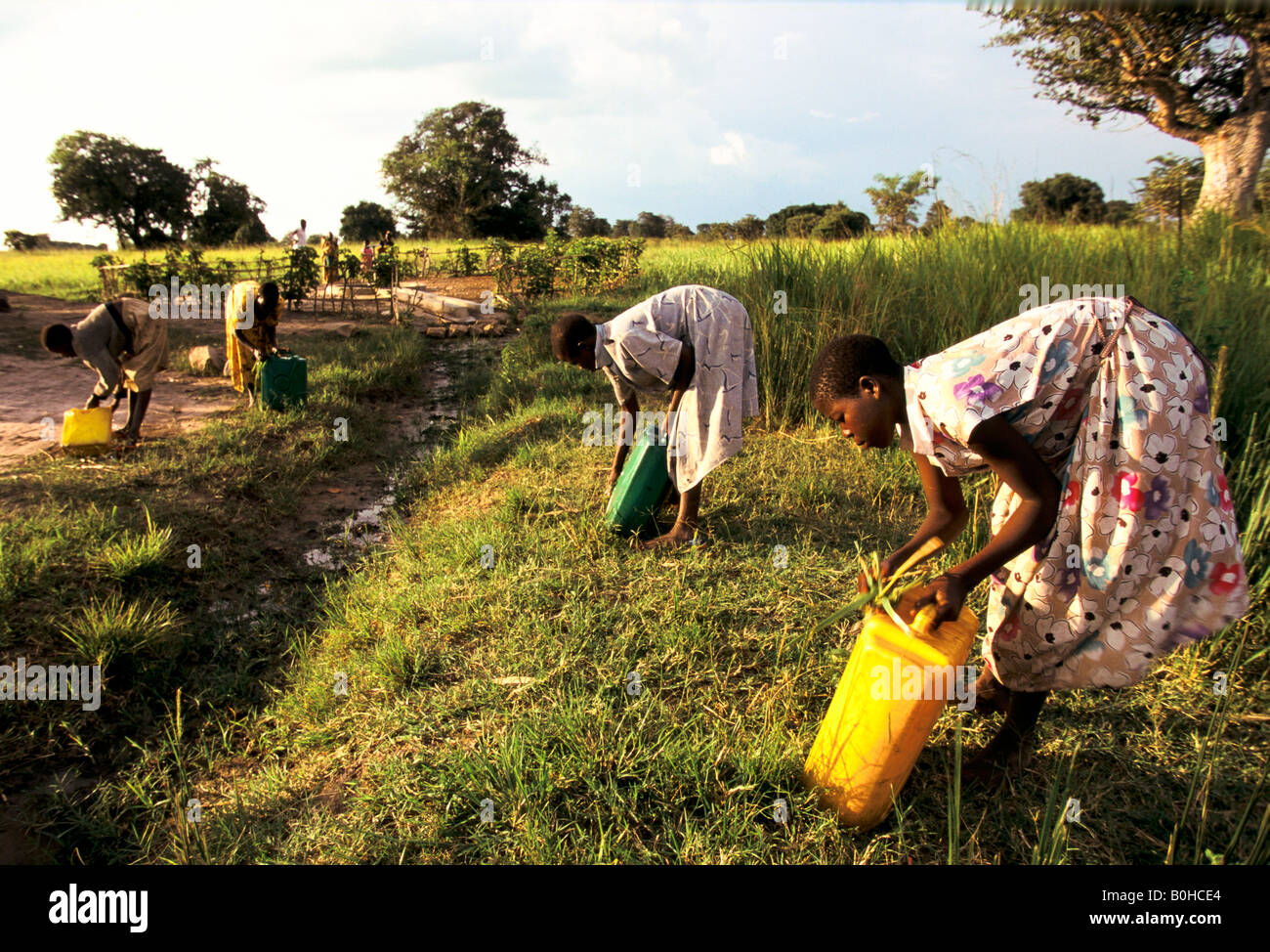 WaterAid workers cleaning jerry cans at a water pump, Aten village, Uganda. Stock Photo