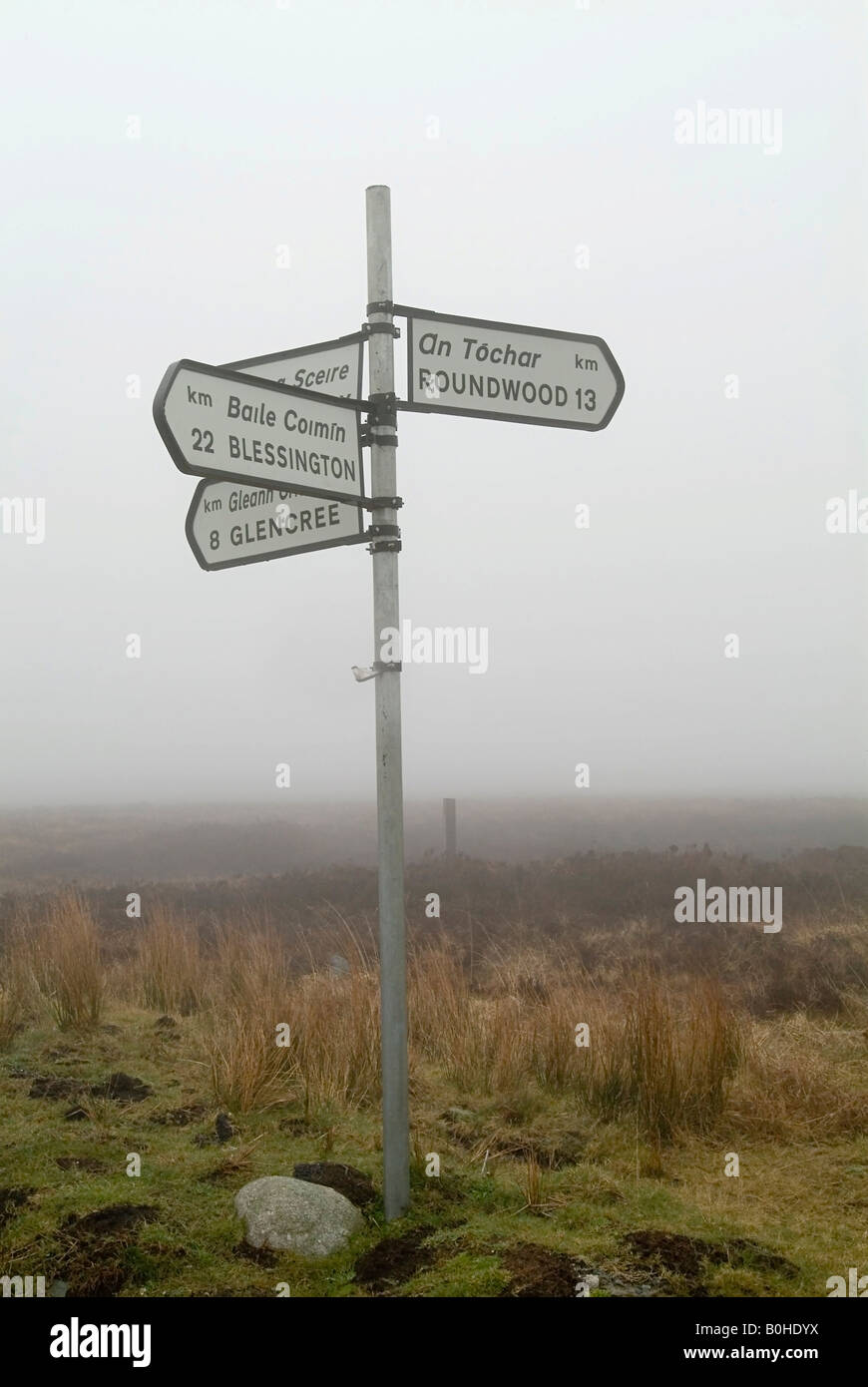 Directional signpost, signs written in English and Gaelic, Wicklow Mountains, County Wicklow, Ireland Stock Photo