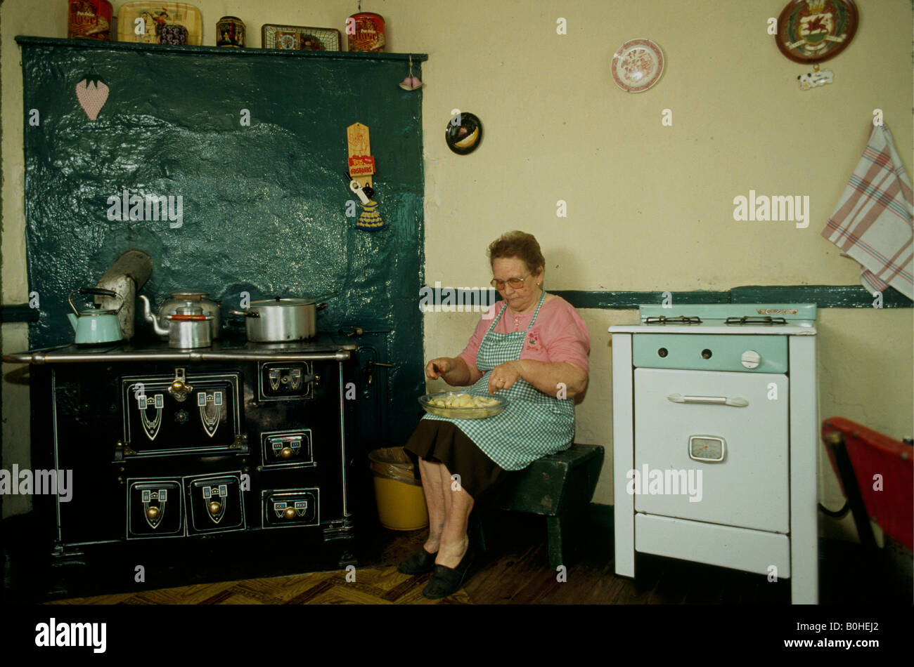 Woman preparing food in the kitchen of a Welsh farm, Patagonia, Argentina. Stock Photo