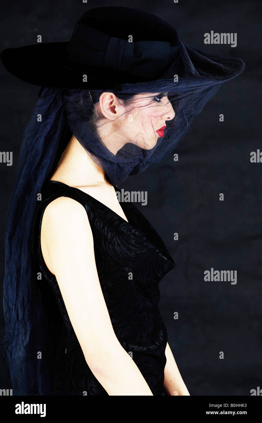 Young woman wearing black and a veil, widow Stock Photo