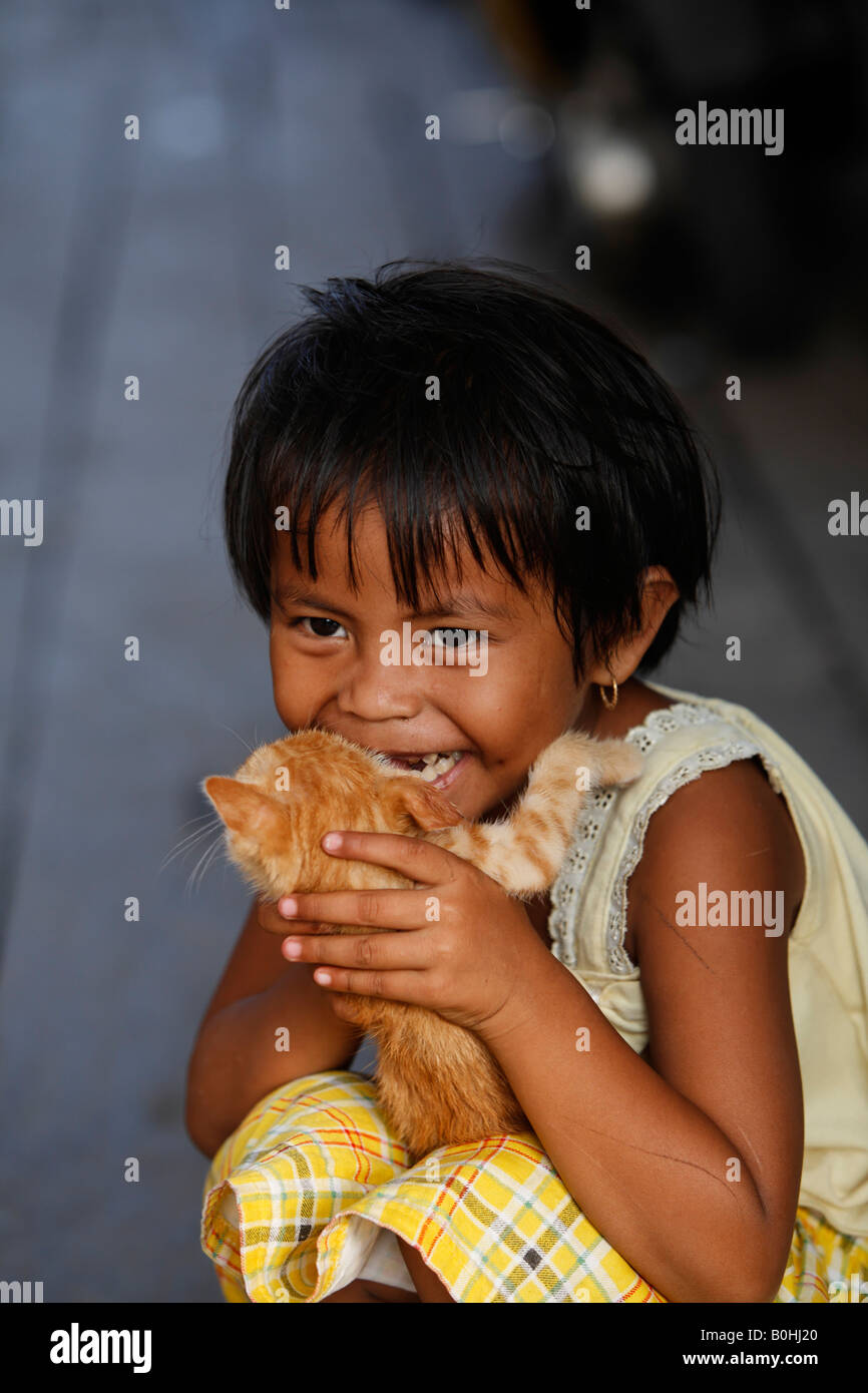 Girl holding a cat, Borneo, Central Kalimantan, Kalimantan Tengah, Indonesia, Asia Stock Photo