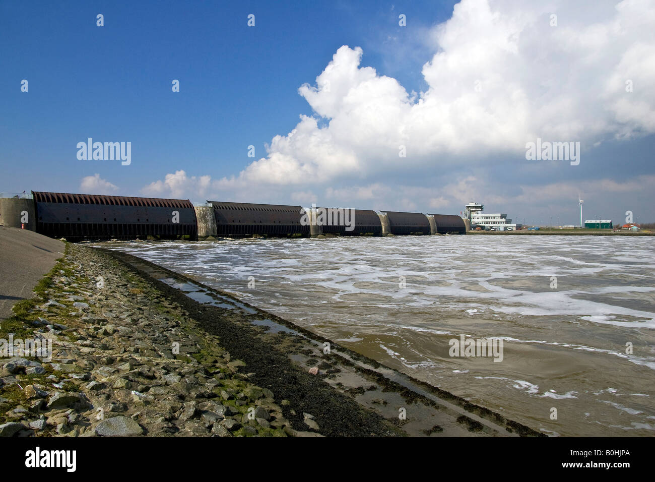 Opened floodgates at the Eider Barrage at the mouth of the Eider River into the North Sea, sea water streaming into the Eider R Stock Photo