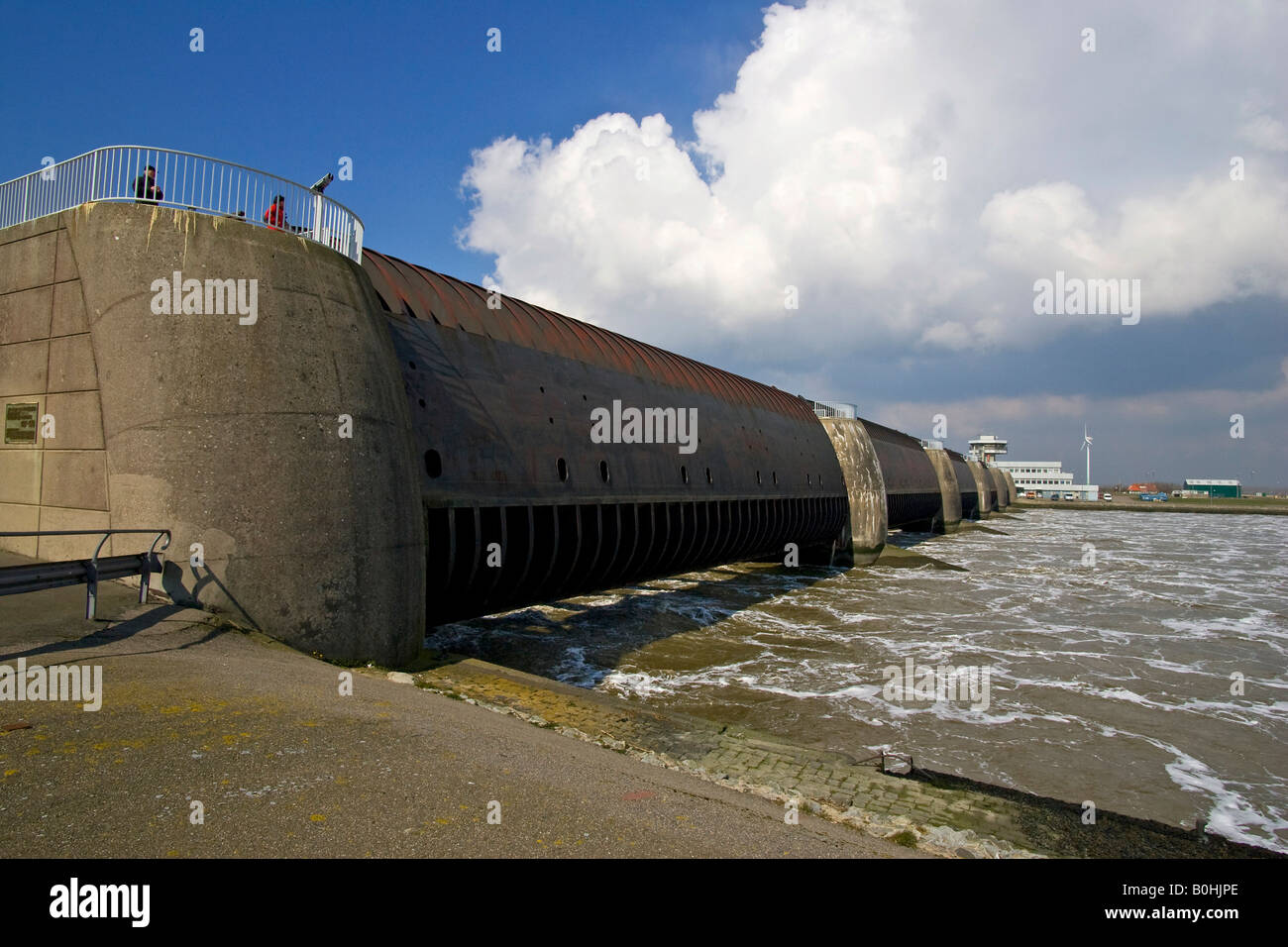 Opened floodgates at the Eider Barrage at the mouth of the Eider River into the North Sea, sea water streaming into the Eider R Stock Photo