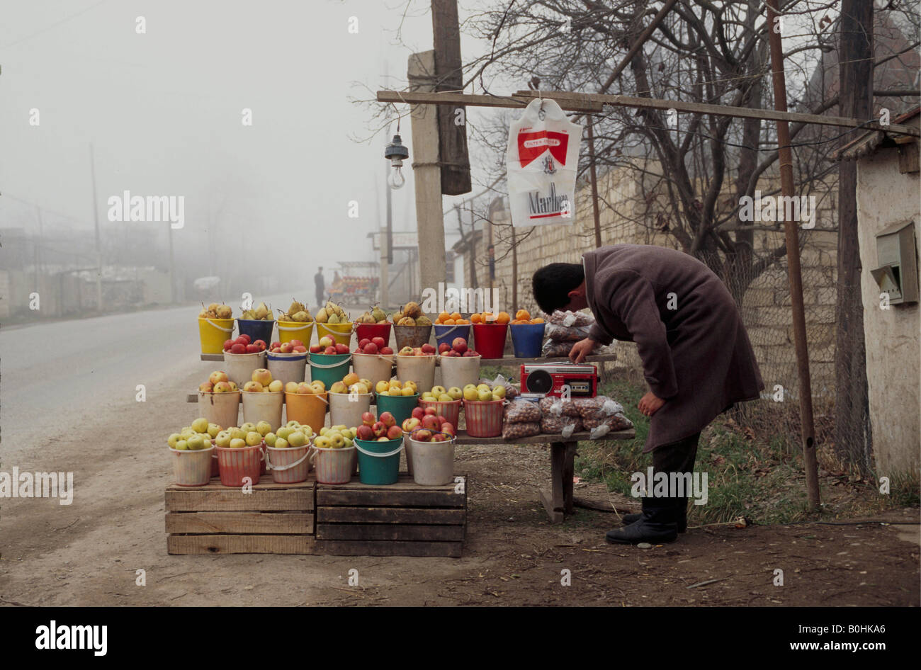 A man selling fruit at a roadside stall, Kuba, Azerbaijan. Stock Photo