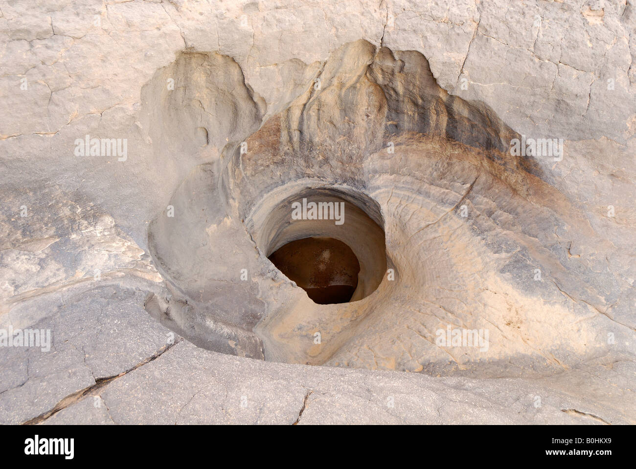 Pothole in a dry river bed, El Ghessour, Tassili du Hoggar, Wilaya Tamanrasset, Sahara, Algeria, North Africa Stock Photo