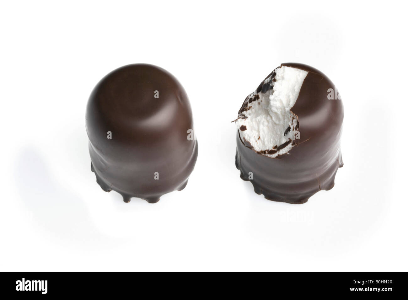 Chocolate-coated marshmallow treats, one bitten into Stock Photo