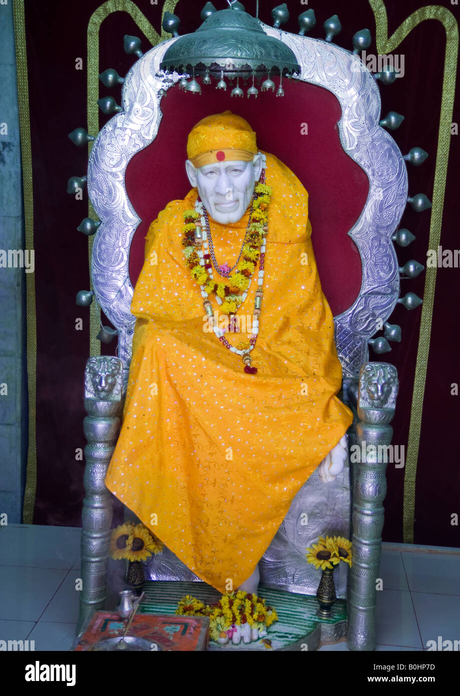 Portrait of Sai Baba of Shirdi at Sai temple in Dwarka where devotees come for pilgrimage to present their prayers of worship. Stock Photo