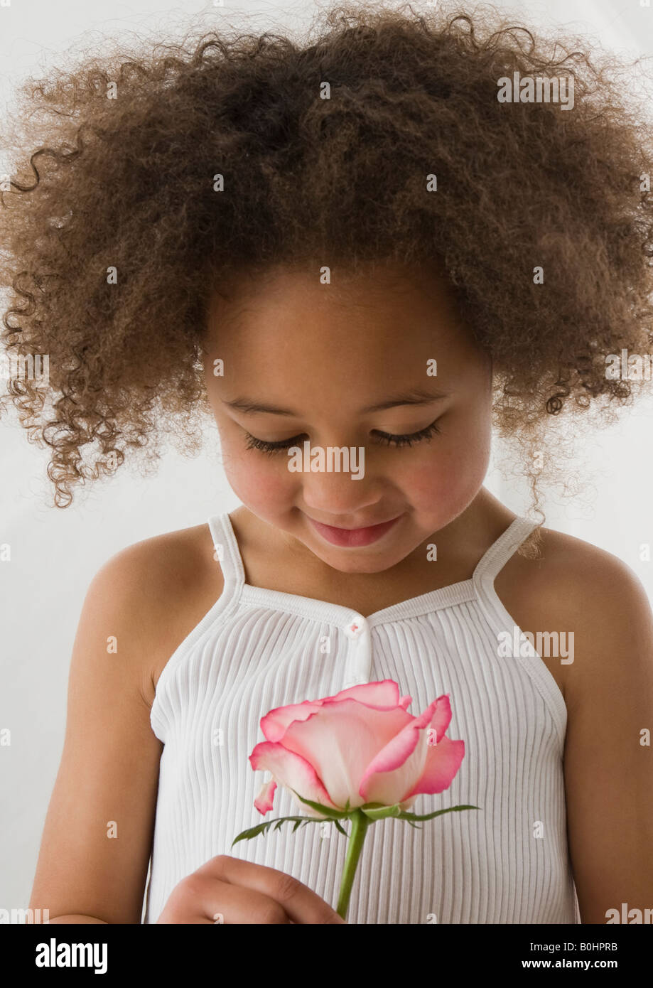 An Adorable Little Girl With Gorgeous Afro Hairstyle In White