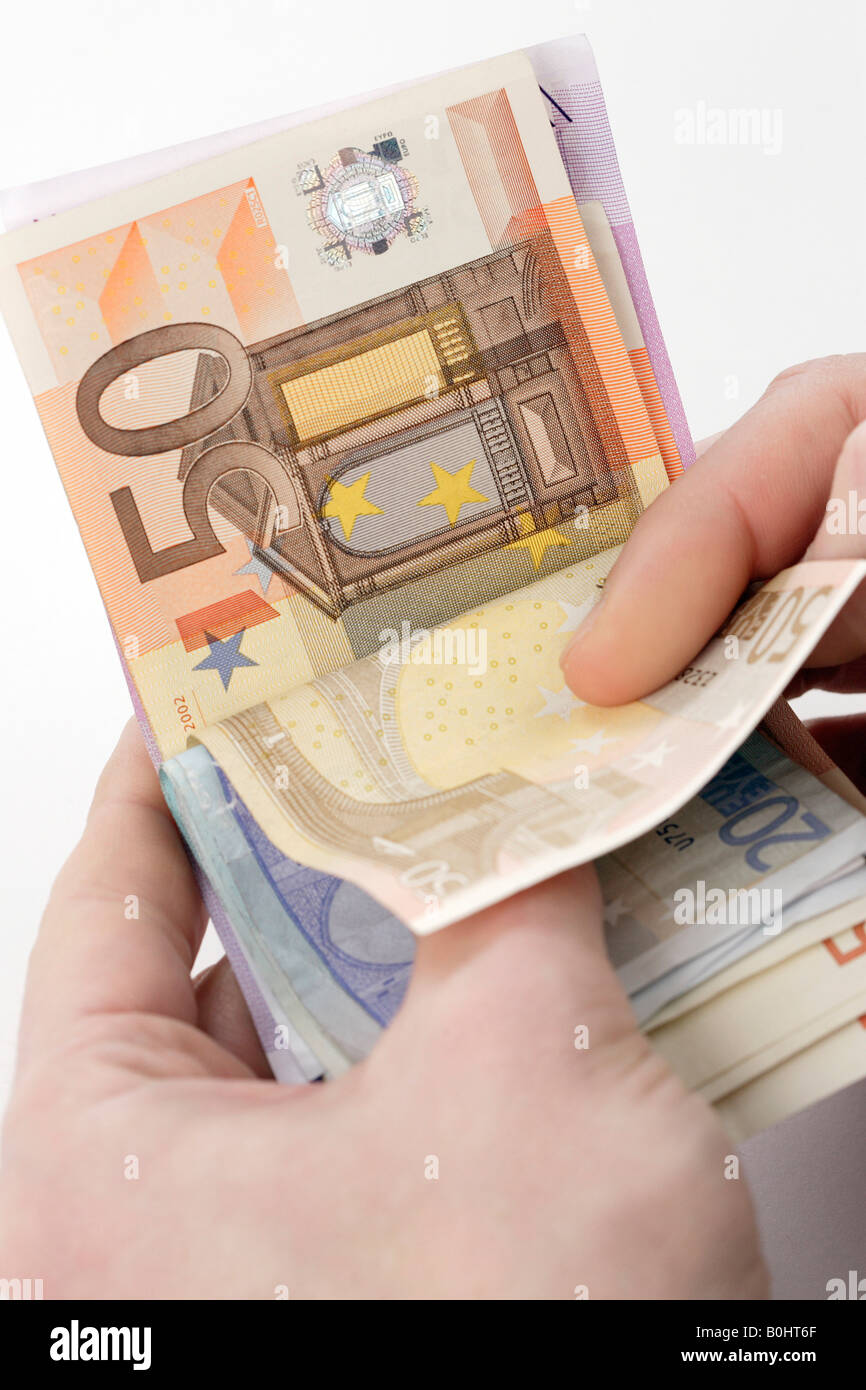 Hands holding Euro banknotes, bills, cash, counting money Stock Photo