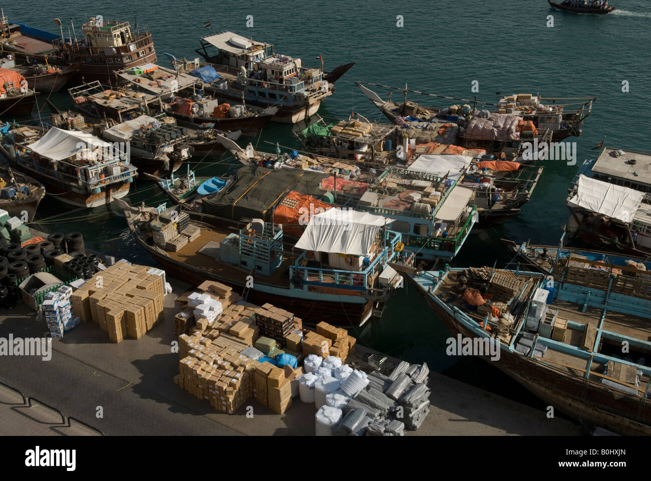 Boats in Dubai creek beat the American embargo by sailing to Iran at night to bring equipment - engines, tyres - and bring back Iranian products. Stock Photo