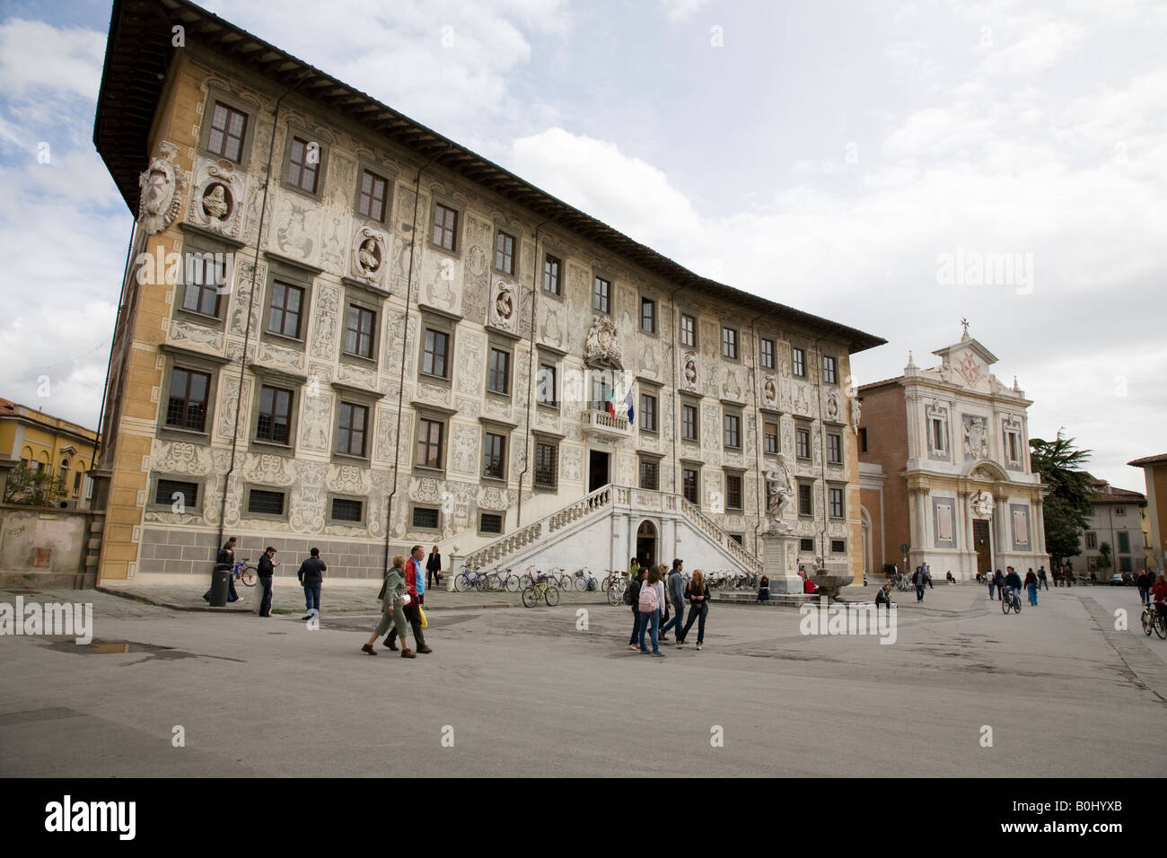 students outside the ornate building of Scuola Normale Superiore University of Pisa Stock Photo