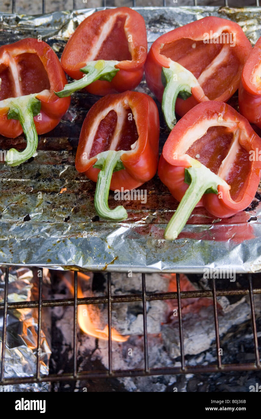 Red bell peppers cooking on the barbecue Stock Photo Alamy