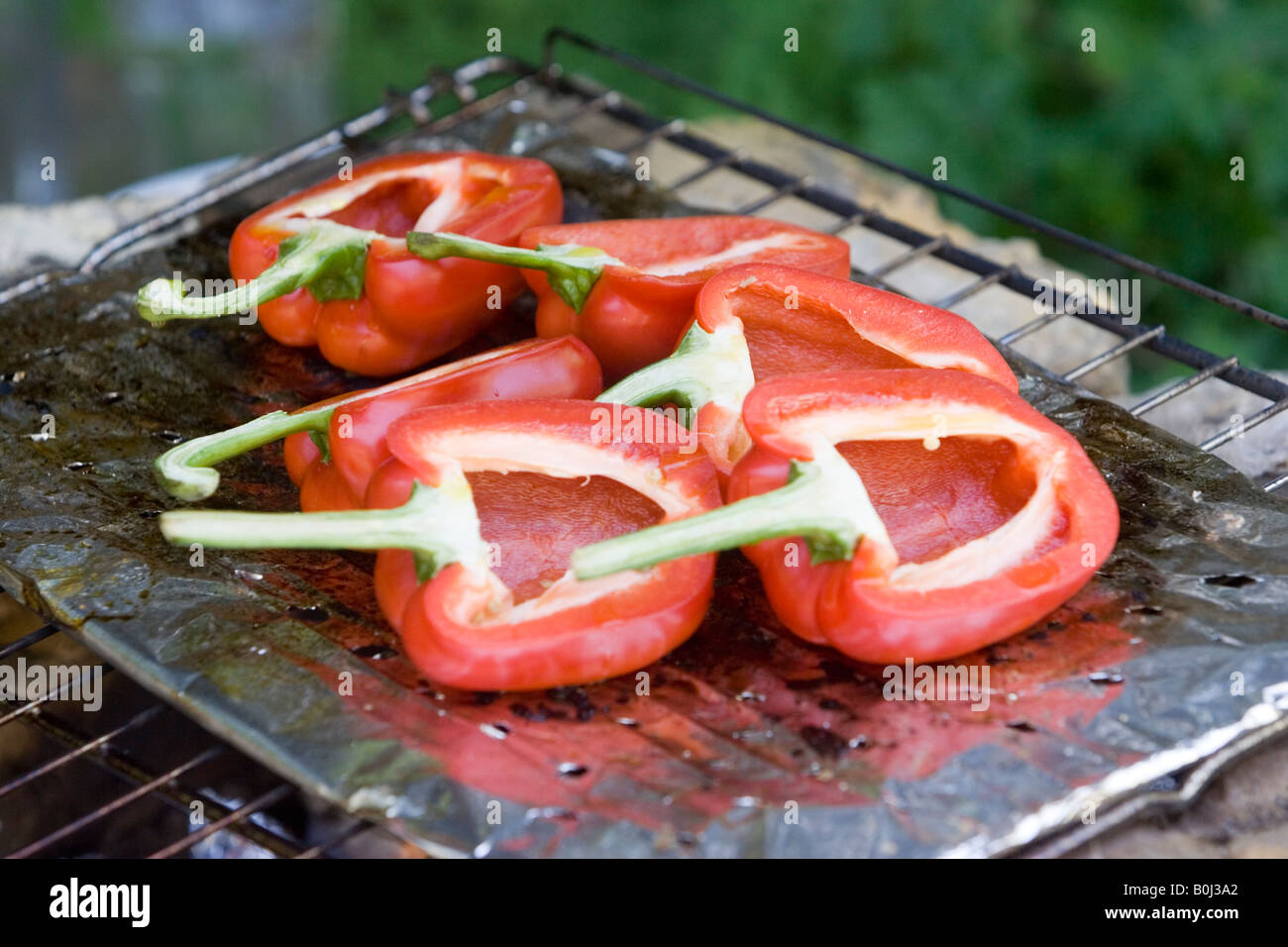 Red bell peppers cooking on the barbecue Stock Photo Alamy