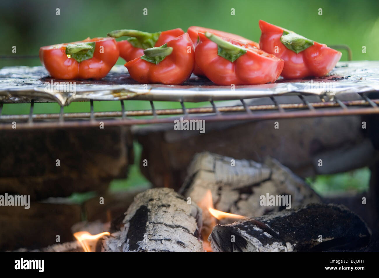 Red bell peppers cooking on the barbecue Stock Photo Alamy