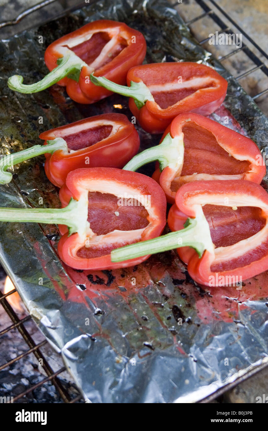 Red bell peppers cooking on the barbecue Stock Photo Alamy