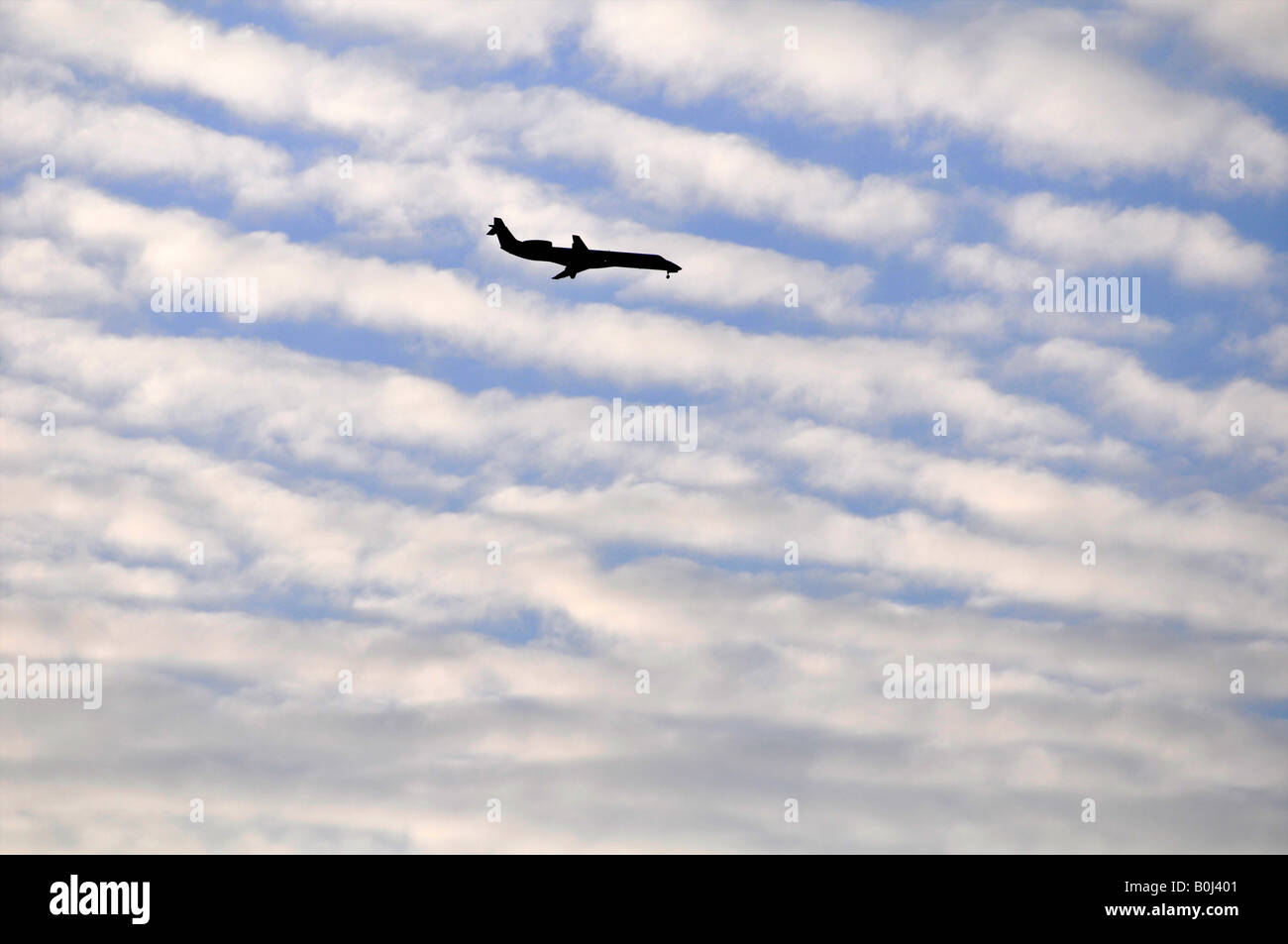 A plane makes it s decent to O Hare International Airport seen from Elmhurst IL Stock Photo