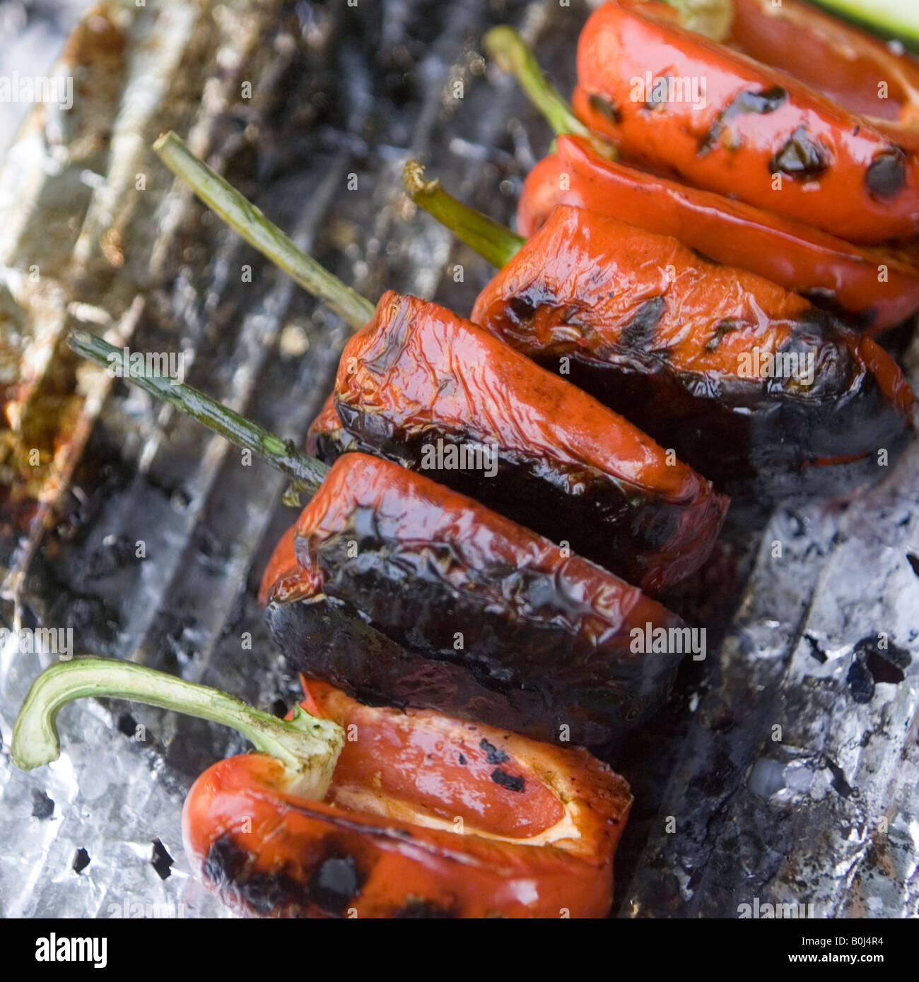 Red bell peppers cooking on the barbecue Stock Photo Alamy