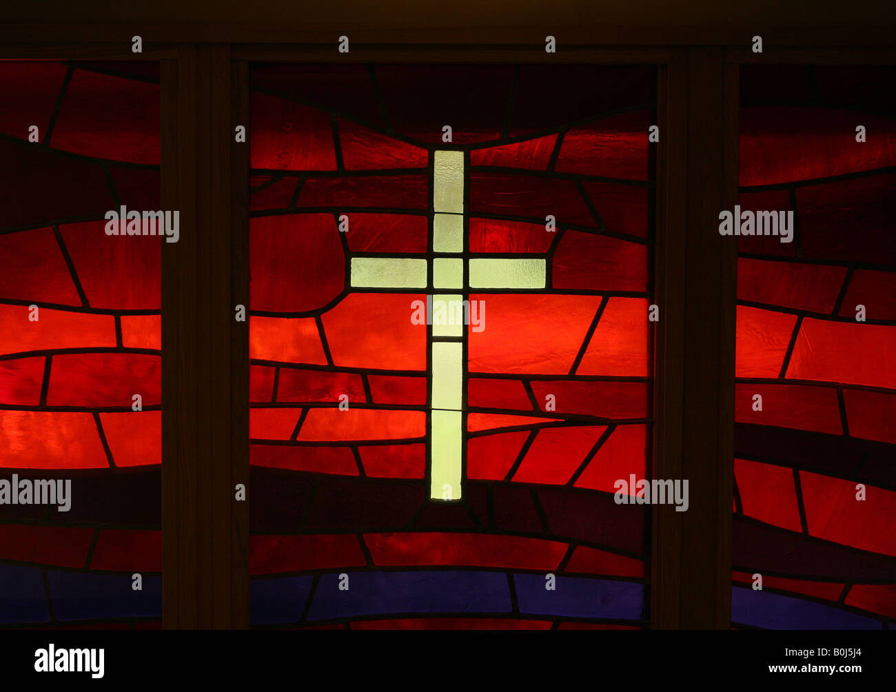 christian cross on red stained glass window of a church Stock Photo - Alamy