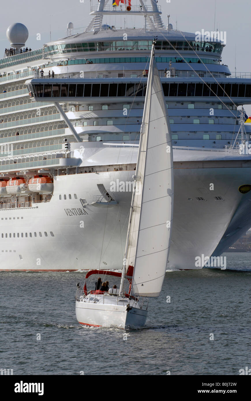 A sailing yacht is dwarfed by P&O cruise ship "Ventura" as she leaves