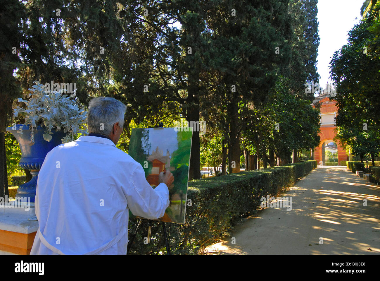 Painter in the Alcazar gardens Seville Spain Stock Photo