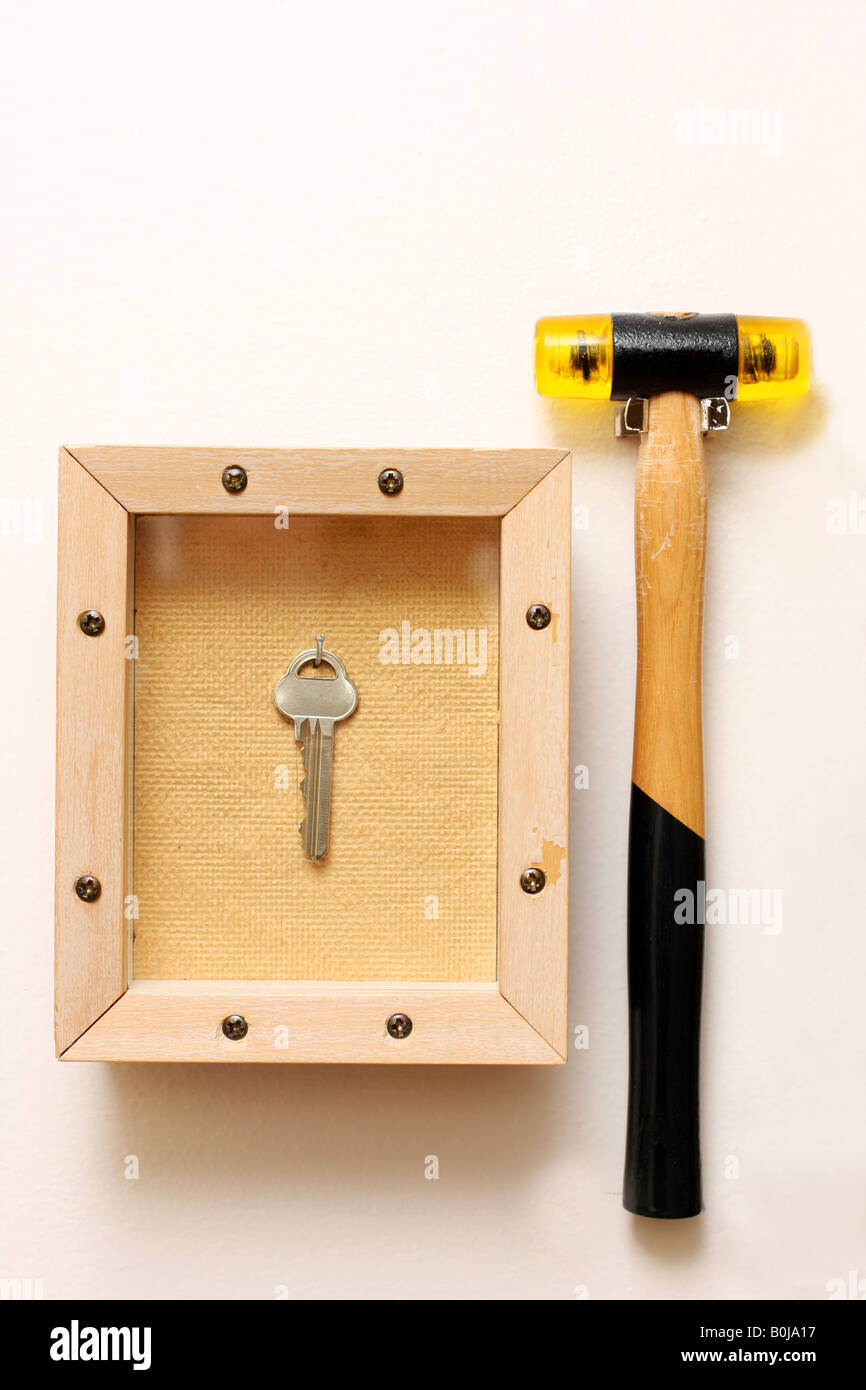 emergency exit hammer on wall and key in glass box Stock Photo