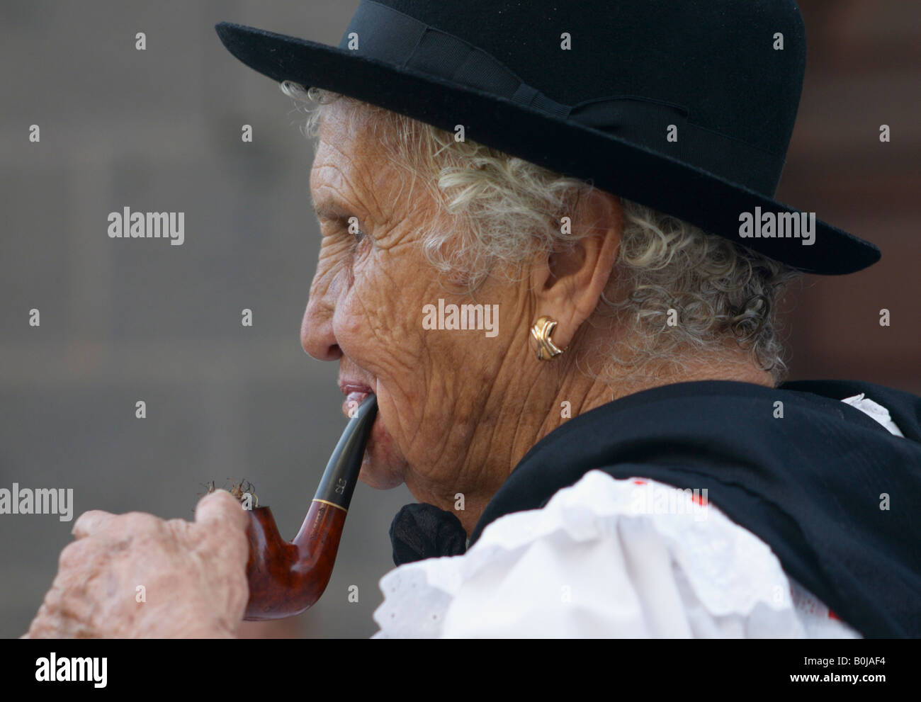Old Spanish woman smoking pipe at fiesta on Gran Canaria Stock Photo - Alamy
