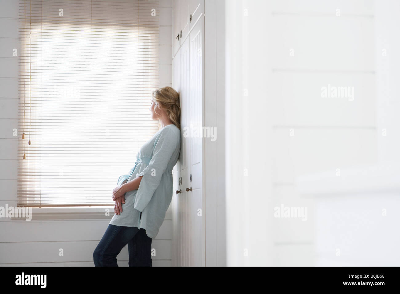 Woman Standing by Bathroom Window Stock Photo - Alamy