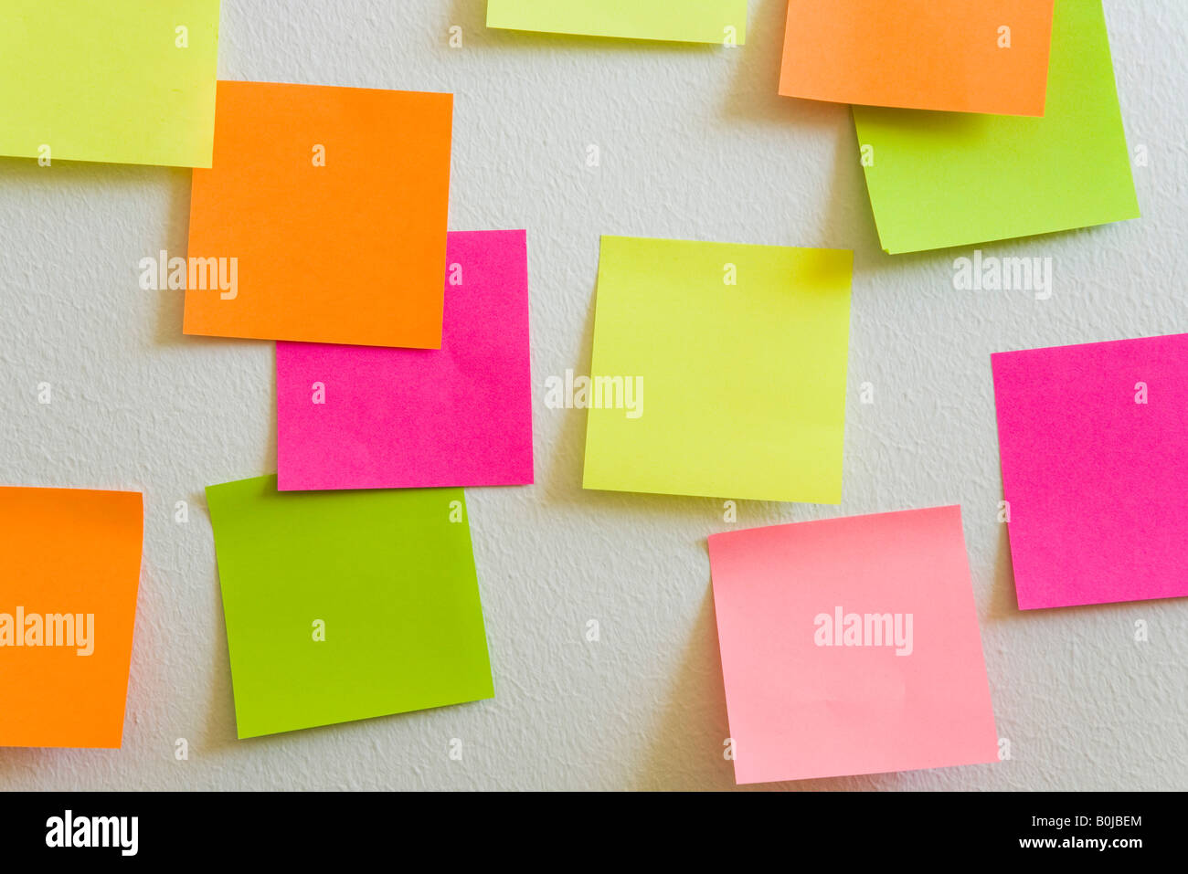 Blank sticky notes attached to a white wall Stock Photo - Alamy