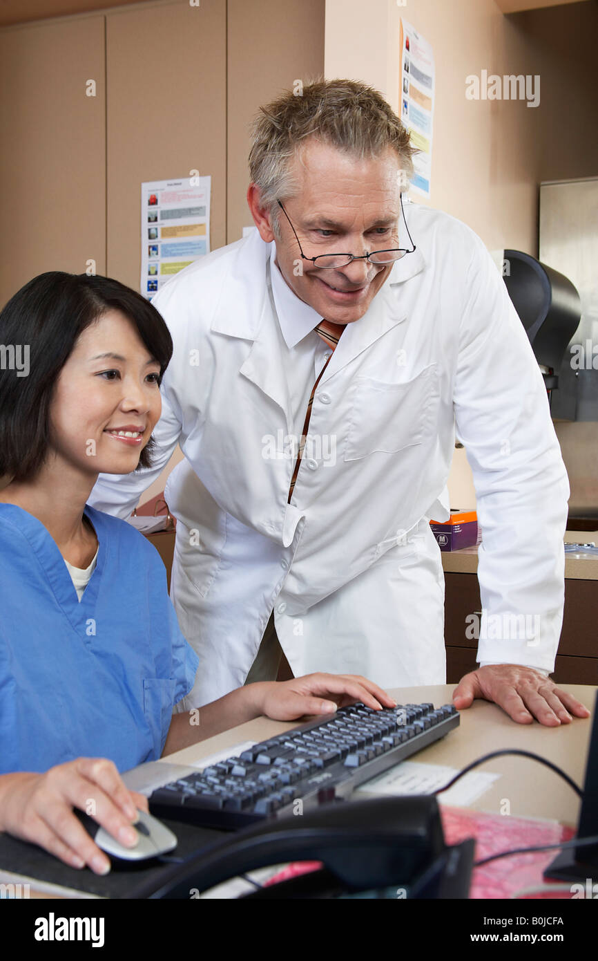 Nurses Working Together Computer Nurse and doctor working on computer Stock Photo - Alamy