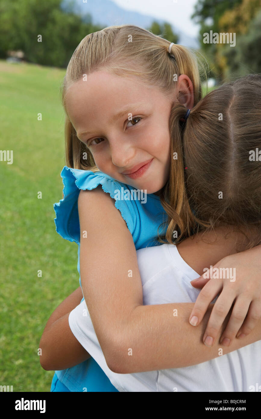 Two girls (7-9 years) hugging, portrait Stock Photo
