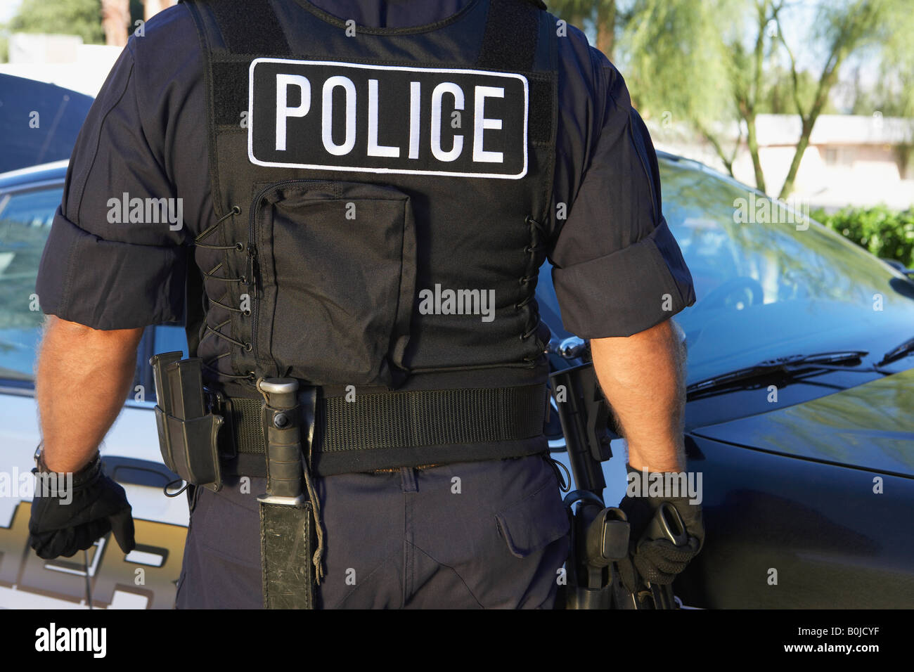 Police officer in bulletproof vest outdoors, back view Stock Photo Alamy