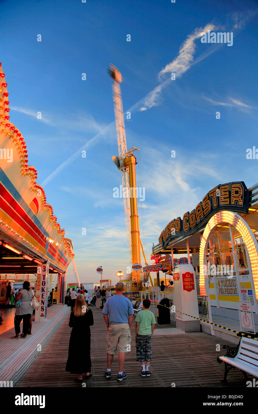 People watching funfair rides Palace Pier Brighton Sussex England ...