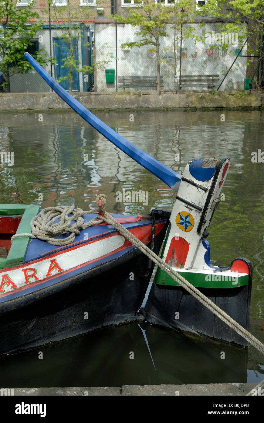 Old wooden rudder and tiller on decorated narrowboat butty, Little Venice, London, England Stock Photo