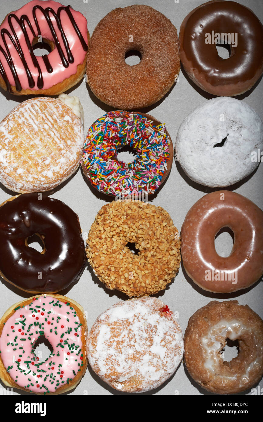 Variety of doughnuts in cardboard box, view from above Stock Photo
