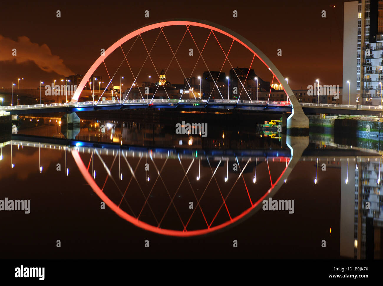 A night view of Glasgow's Clyde Arc bridge known localy as the Squinty Bridge due the angle it crosses the water. Stock Photo
