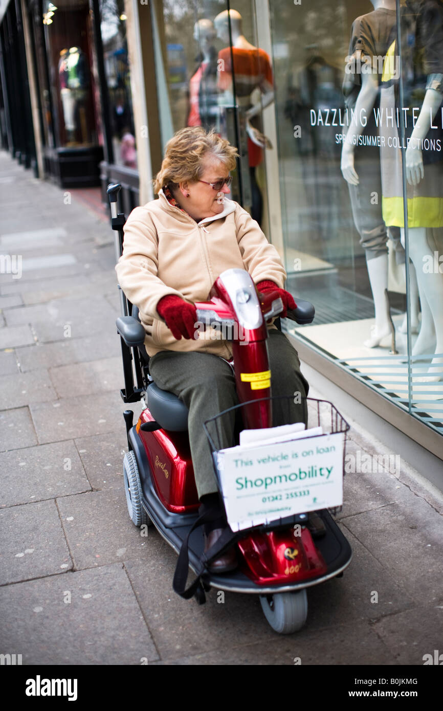 Pensioner on a Shopmobility scooter in Cheltenham town centre Stock Photo Alamy