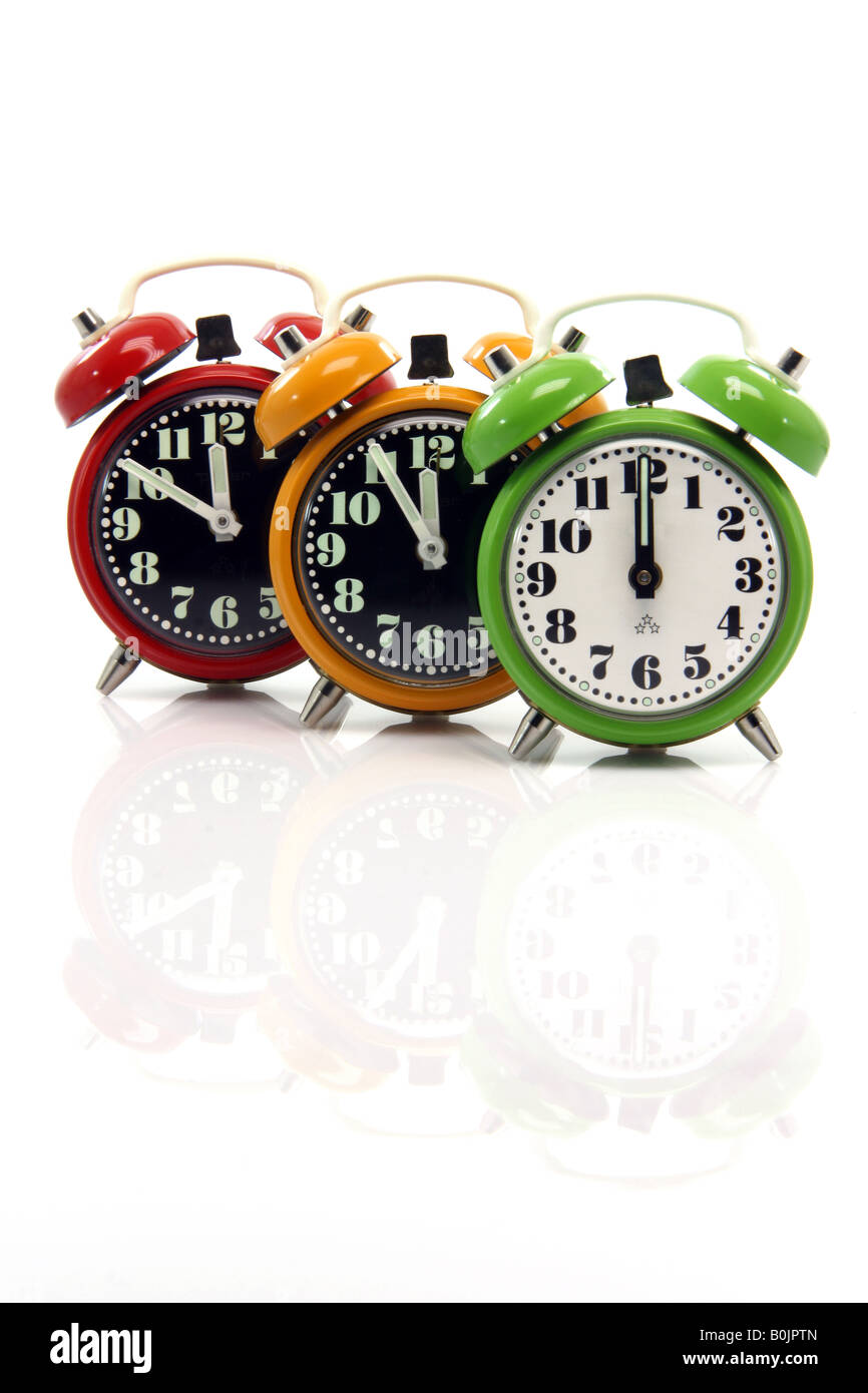 timing red yellow and green alarm clock untill twelve oclock closeup with nice reflection vertical Stock Photo