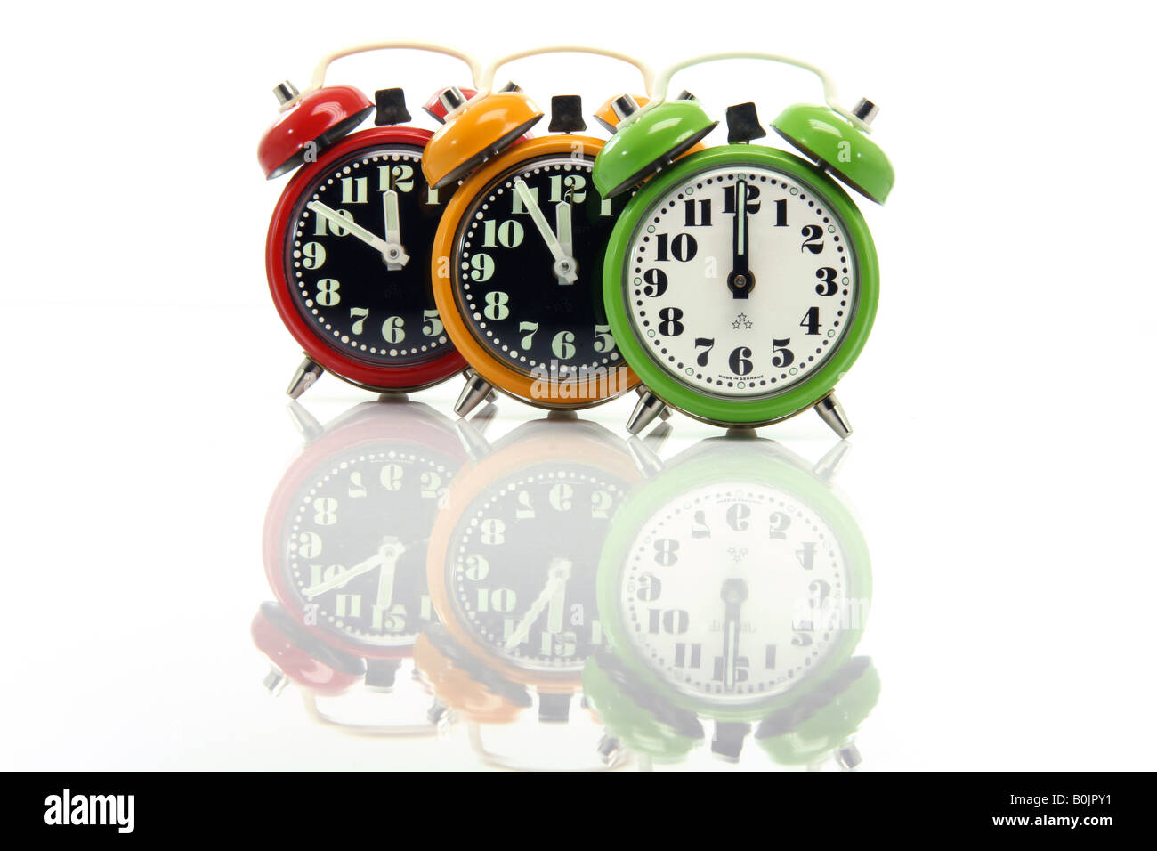 timing red yellow and green alarm clock untill twelve oclock closeup with nice reflection Stock Photo