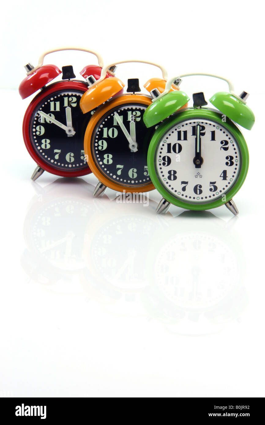 timing red yellow and green alarm clock untill twelve oclock closeup with nice small reflection vertical Stock Photo