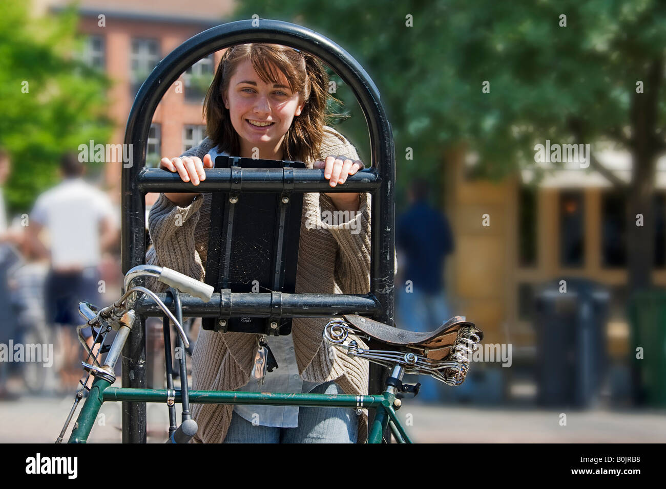 Student looking through  locked bike. Cambridge. Stock Photo